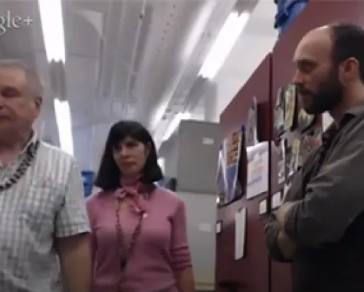 ROM staff Deb Metsger, Tim Dickinson, and Dave Ireland stand in an office environment to tour the botany collection.
