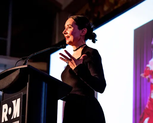 Woman speaking on stage
