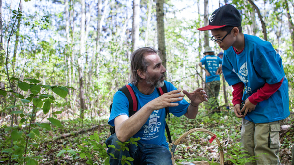 ROM scientist Jean-Marc Moncalvo gestures to a young boy to explain something about fungi during a guided bioblitz hike through the forest during the 2014 Ontario BioBlitz