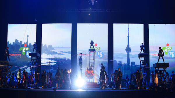 A stage performance with images of Toronto in the background for the opening ceremonies of the 2015 Pan Am Games in Toronto