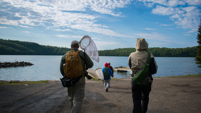 The insect team travels with nets in hand on a chilly morning towards the dock. Photo by Adil Darvesh