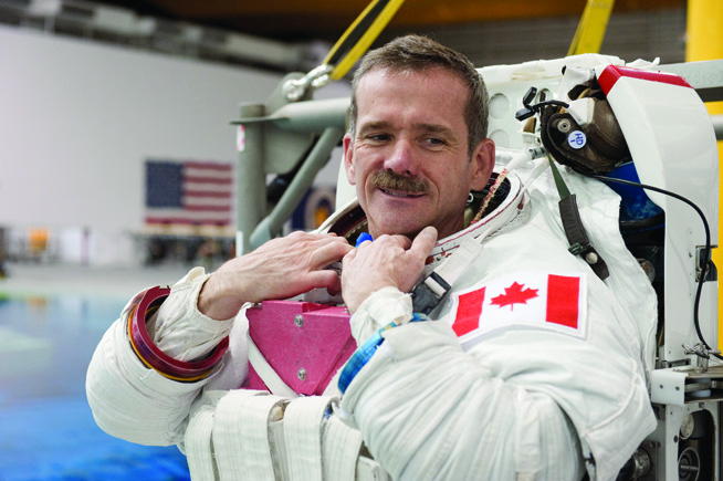 A photograph of a man in an astronaut suit without a helmet