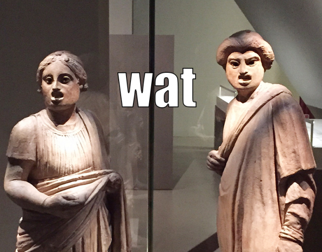 Photo: two Pompeian sculptures making silly faces. Caption: Wat. 