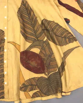 Leaves stitched on to a yellow blanket.