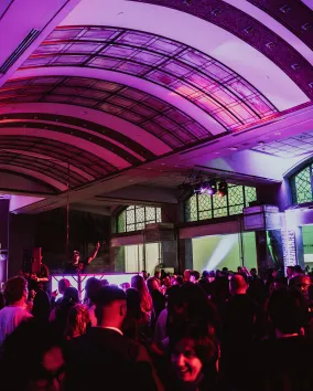 A DJ performing for a crowd at Royal Ontario Museum in the Currelly Gallery.