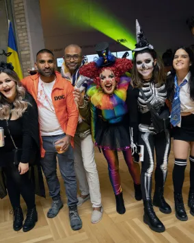 A group of people in Halloween costumes in the museum.