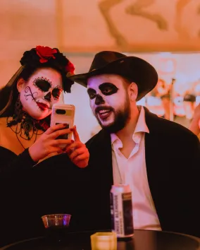 A woman and a man dressed up for Day of the Dead celebrations.