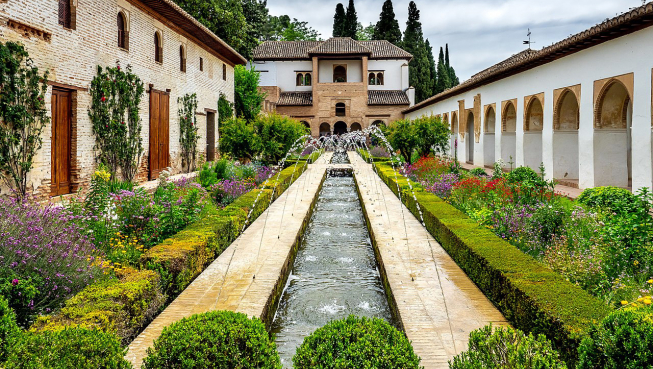 A lush garden with fountains inside a courtyard.