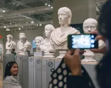 Guest taking a photo of sculptures at ROM