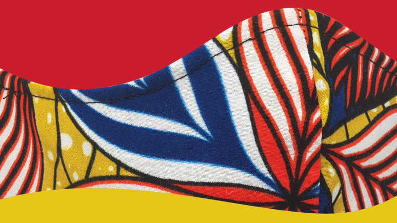 Detail of yellow, blue, red, white, and black printed cotton face mask.