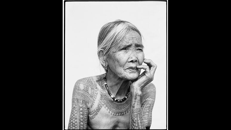 Black and white image of a tattooed woman.