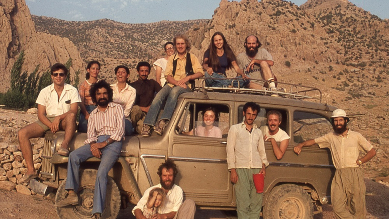 Archival photo of people posed on a car.