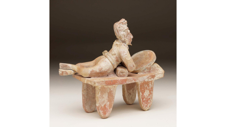 Clay statue reclining noble looking into a mirror