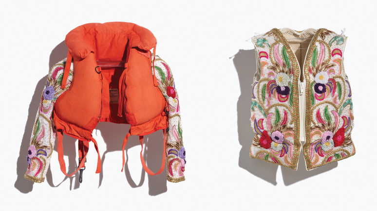 Image of an adult and a child's repurposed life jackets, the adult's completely covered, and the child's embellished with added sleeves, in a colourful beaded fabric depicting a floral pattern in reds, pinks, greens, and gold. Side-by-side image of both jackets taken on a white background.