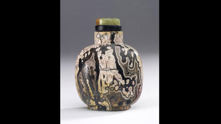small bottle with marbled pattern and jade lid.