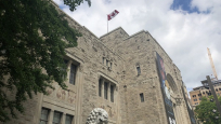 View of Canadian flag and lion statue outside of ROM