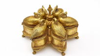 Un boîtier doré à six compartiments disposés de façon circulaire et ornés de six oiseaux en or