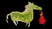 Drawing of a green horse standing next to a doll wearing a dress on