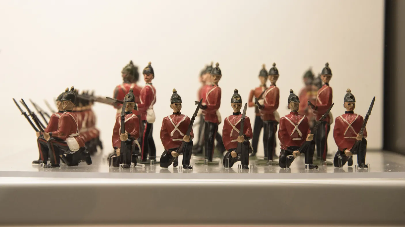Close-up of a group of toy soldiers in red jackets standing in formation