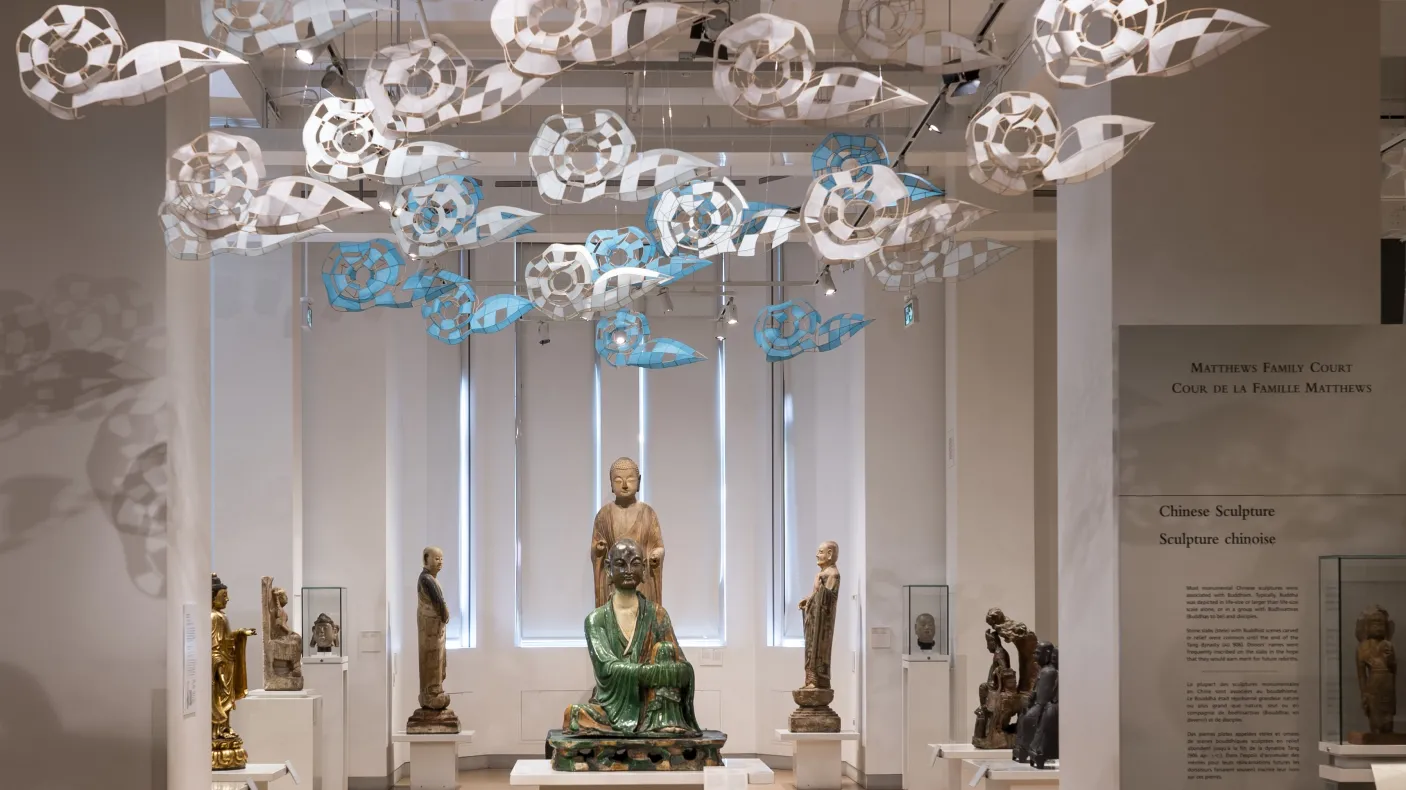 Paper clouds floating above Chinese statues