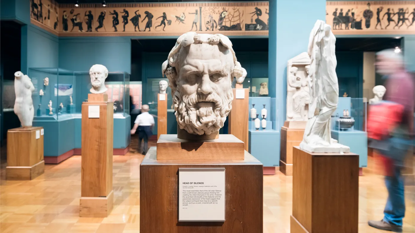 The stern face of Silenos carved in marble stares