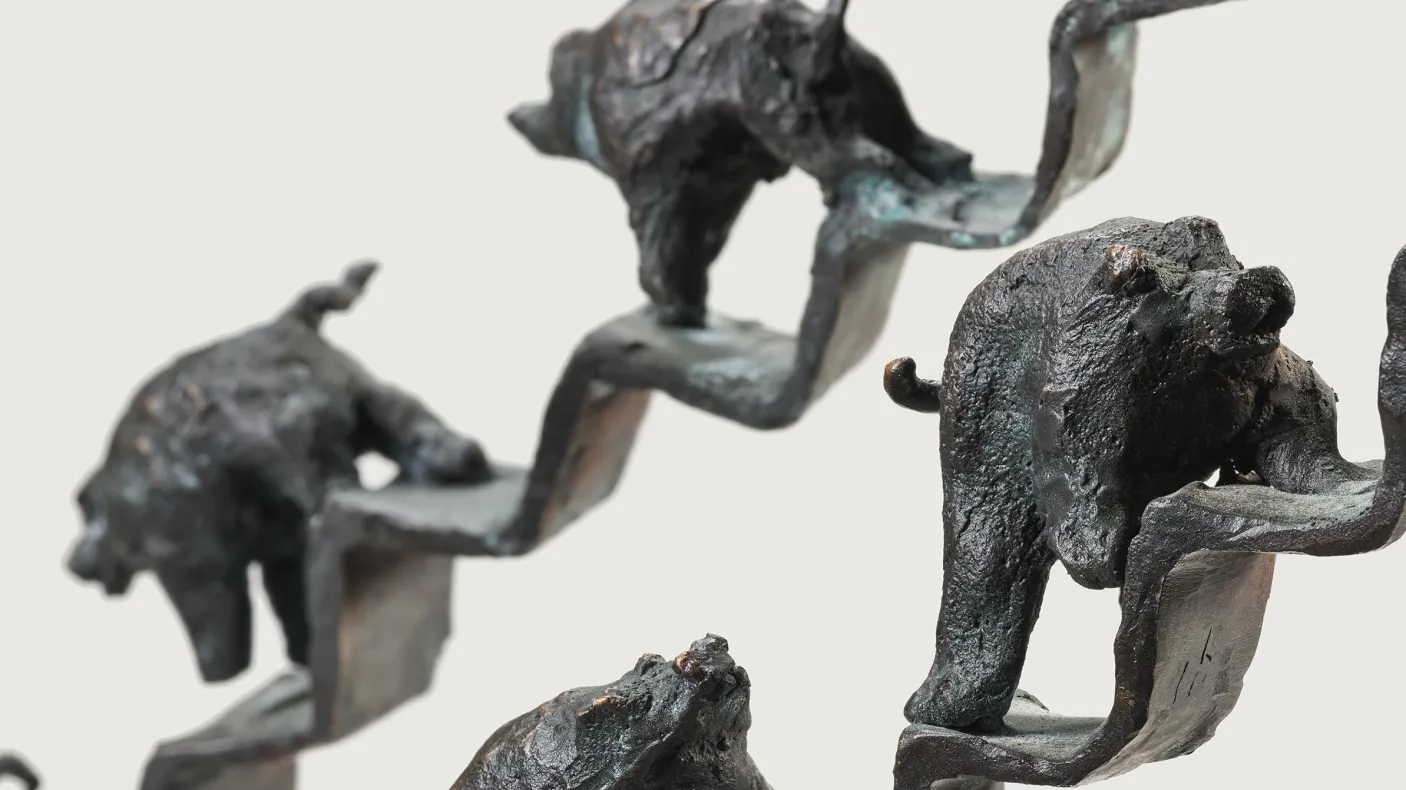 Sculpture of pigs walking up and down a staircase 