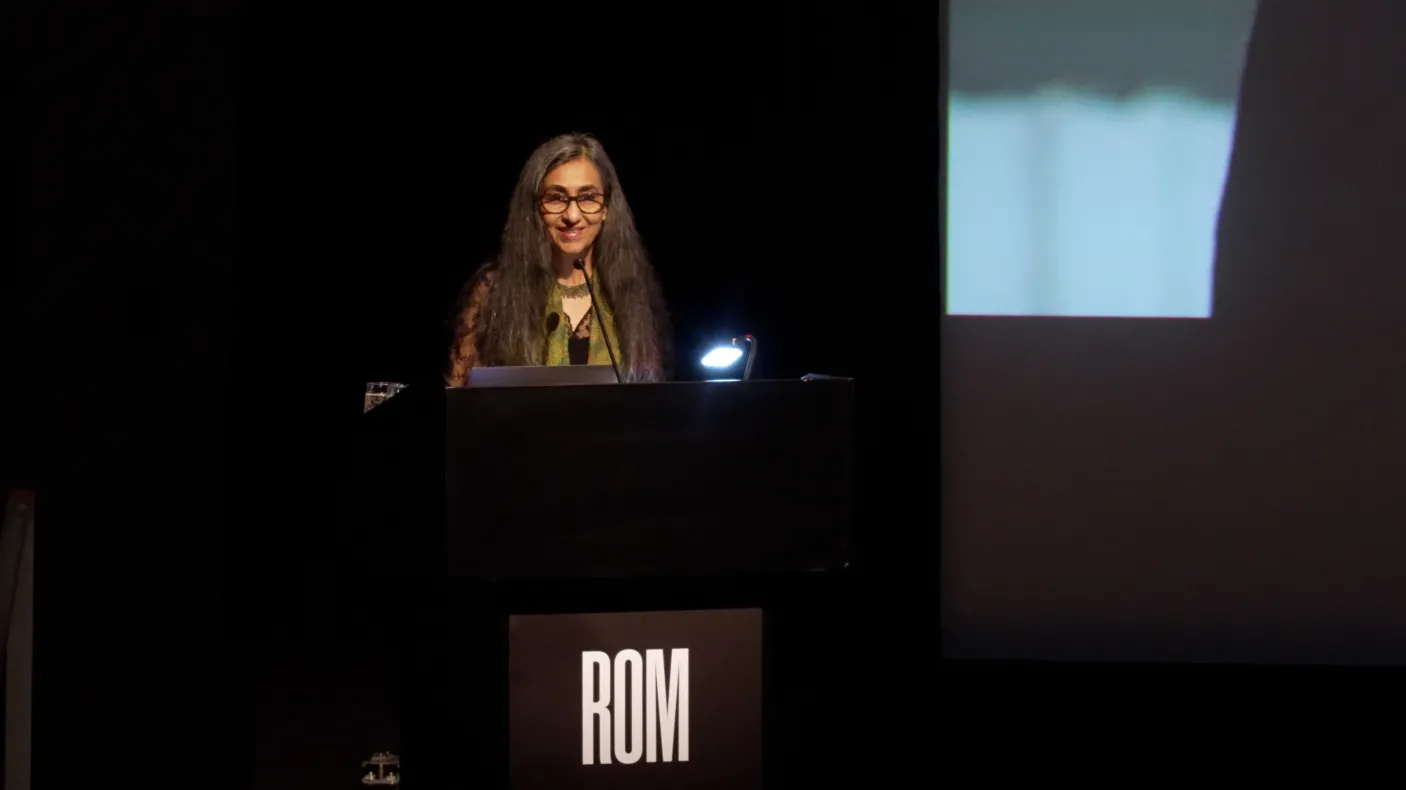 Woman standing on stage.