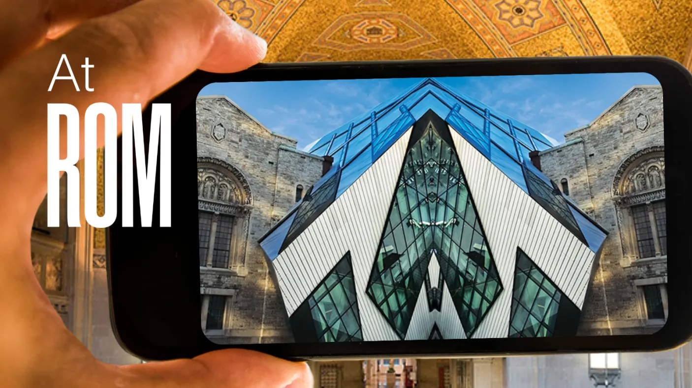 A hand holds up a phone displaying an image of the Royal Ontario Museum mirrored down the middle. Text reads at ROM.