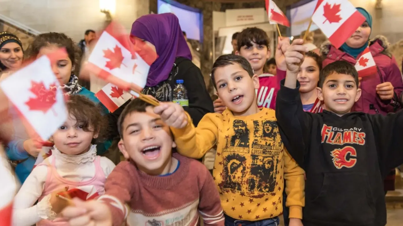 Kids waving Canadian flags