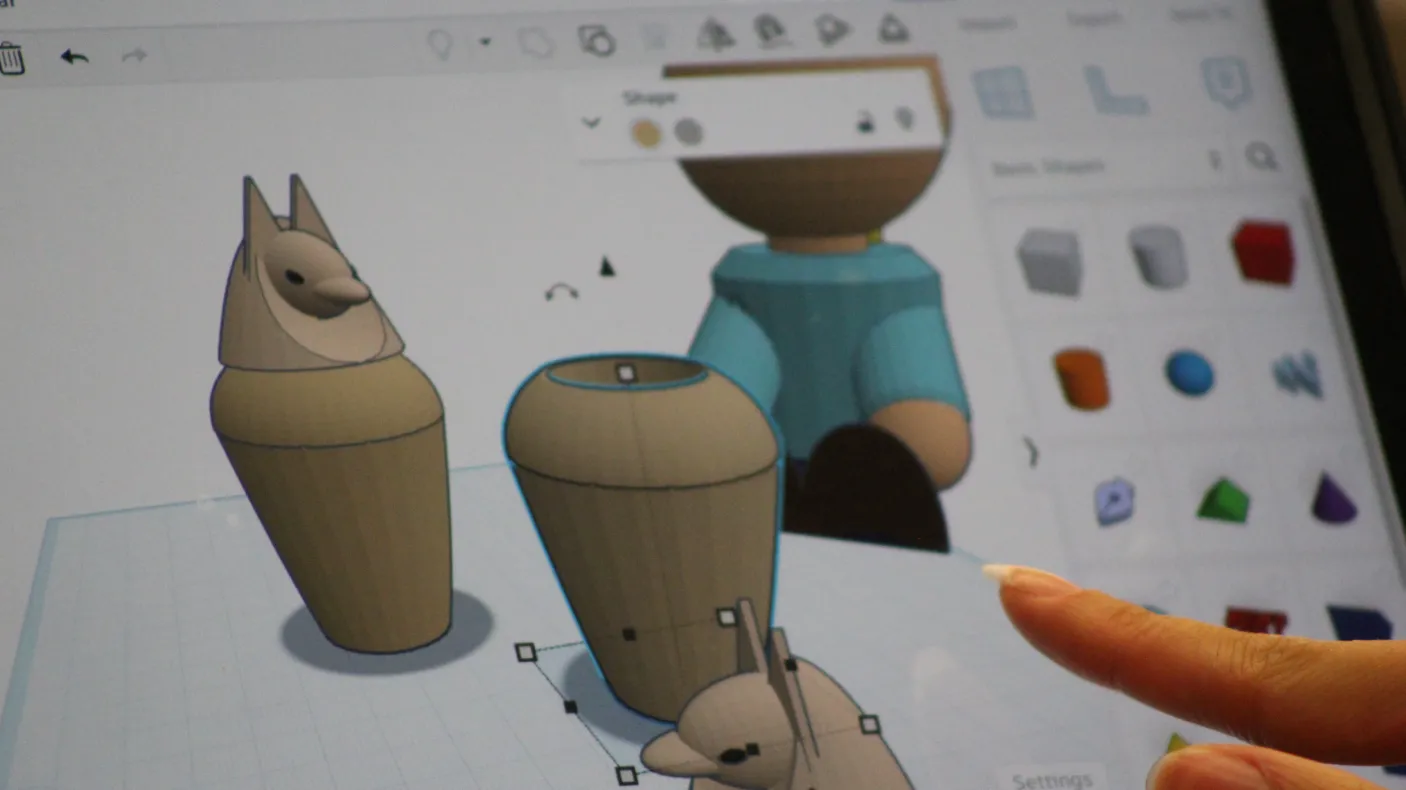 An ipad screen displays a program creating 3D models of canopic jars