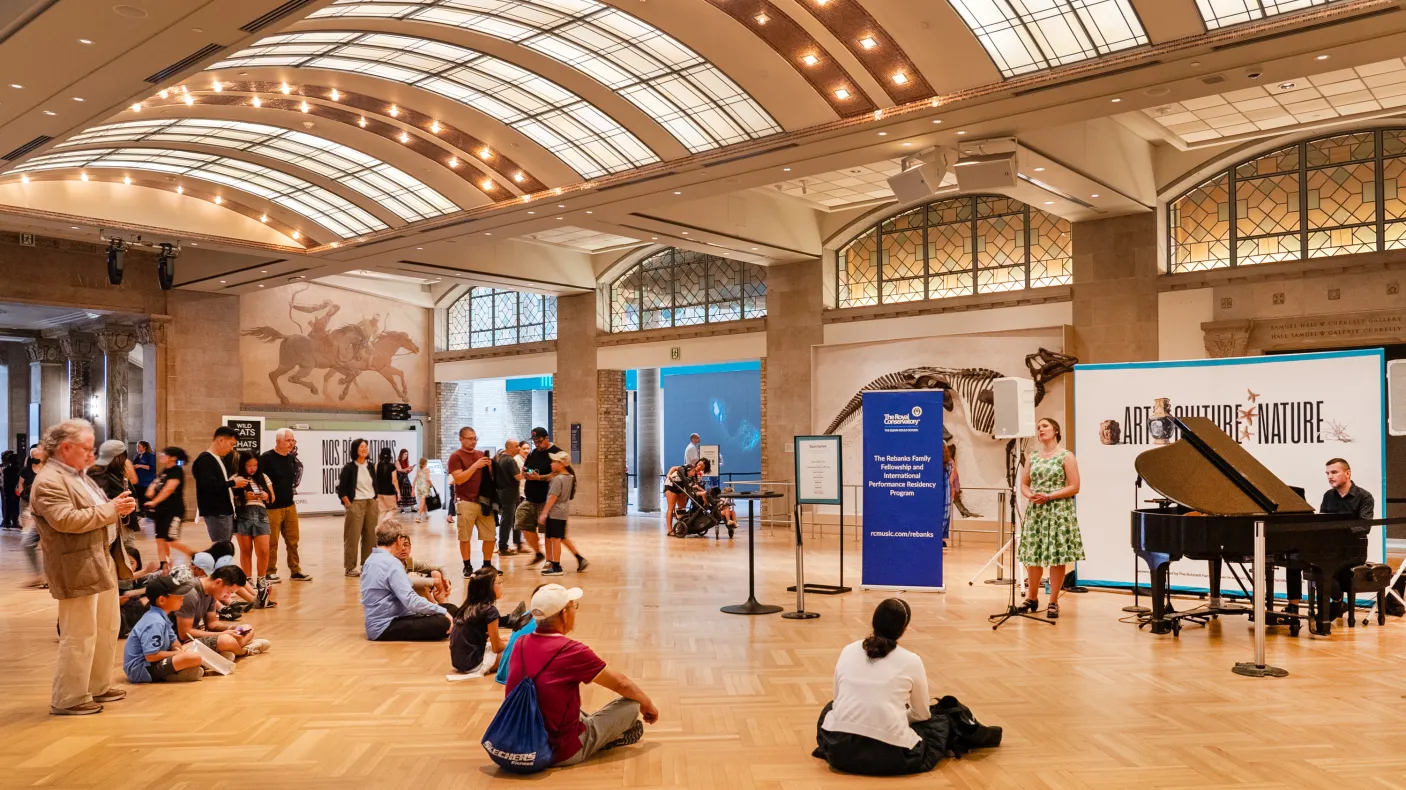 Gathering around a performance on the main floor at the Royal Ontario Museum. 