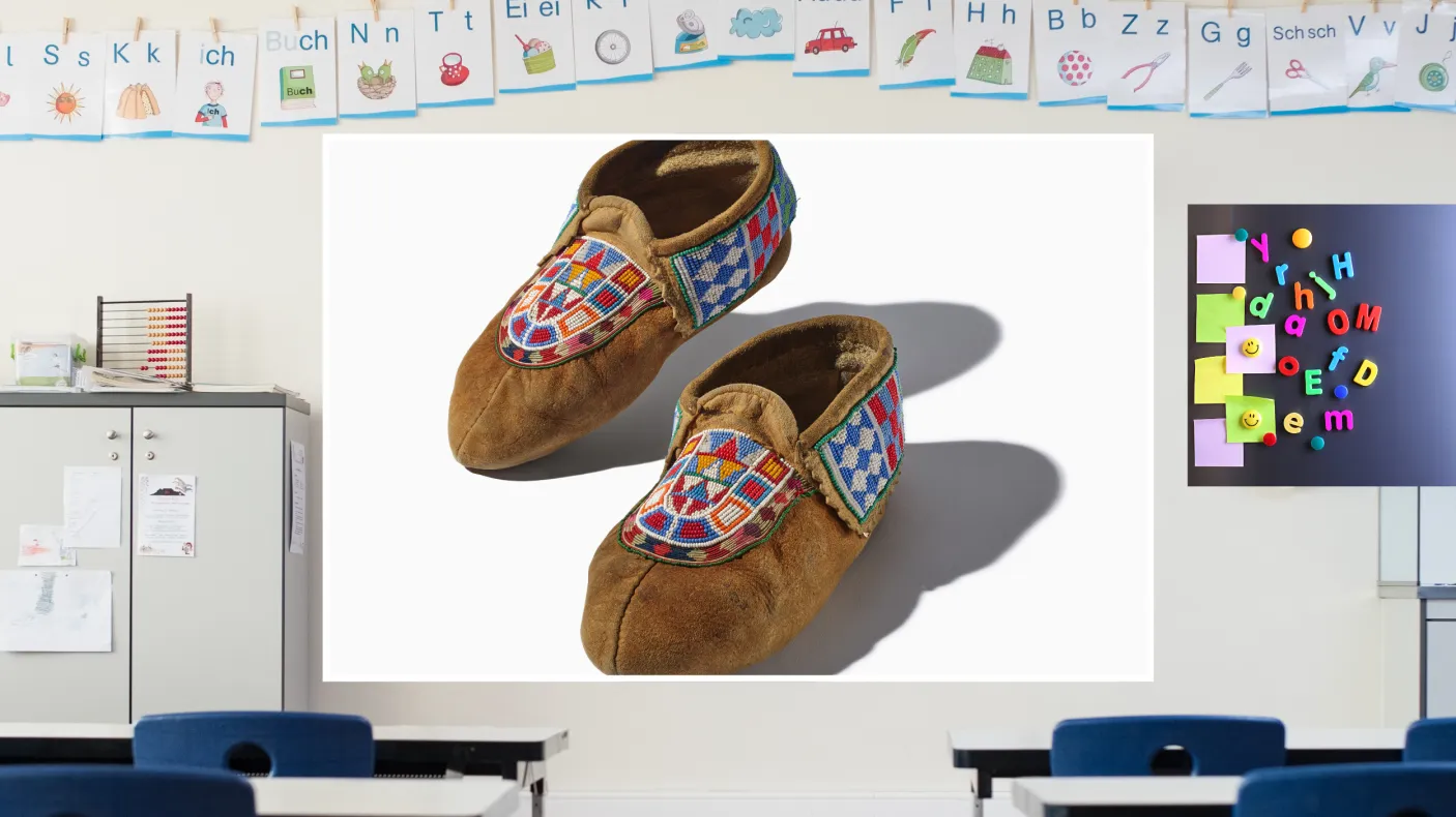 A screen in a colourful classroom displays a pair of beaded leather moccasins