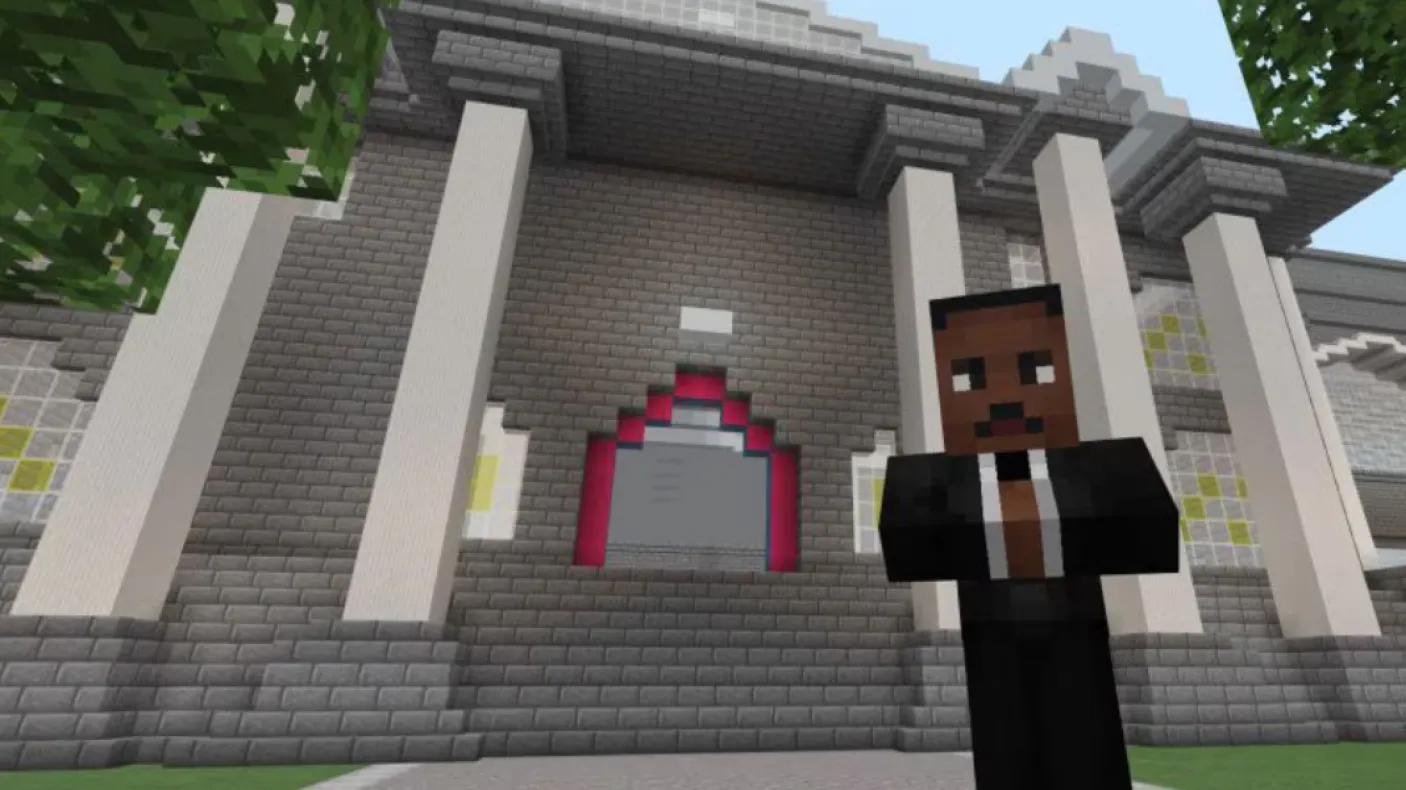 A Minecraft screenshot of a game character with dark skin and a suit standing in front of a large building with classical columns.