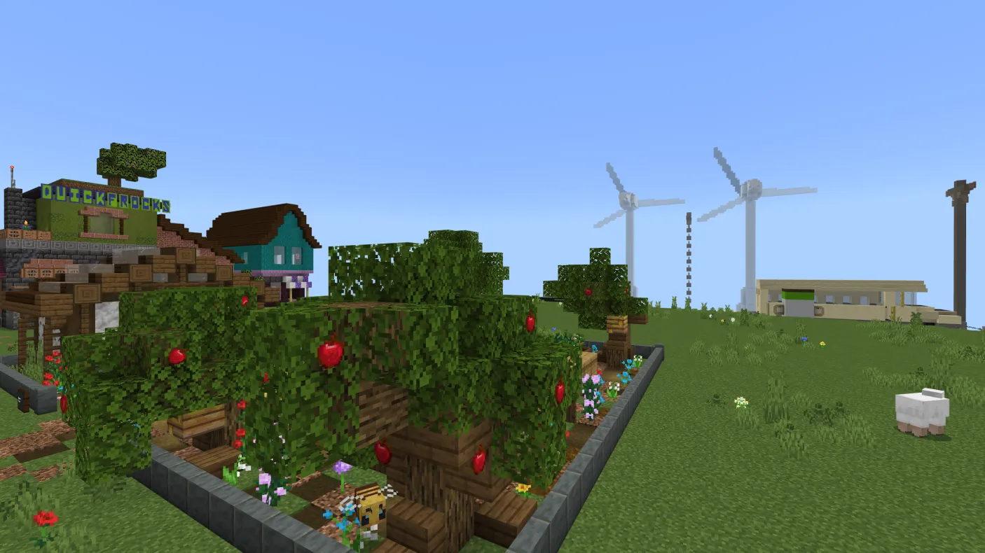 A Minecraft screenshot of a community garden with windmills visible in the background.