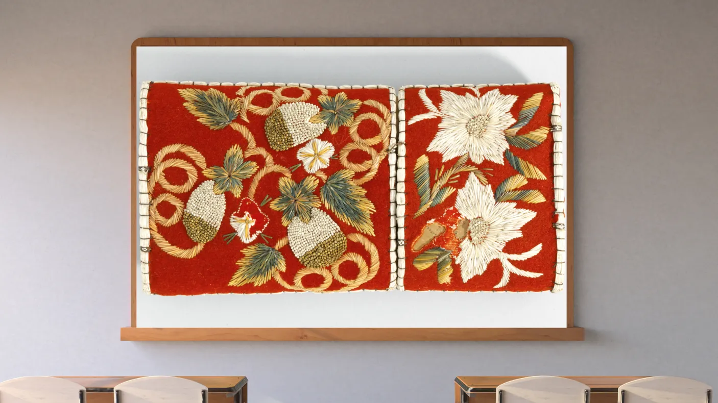 A screen in a classroom shows an image of beaded strawberries against a red background.