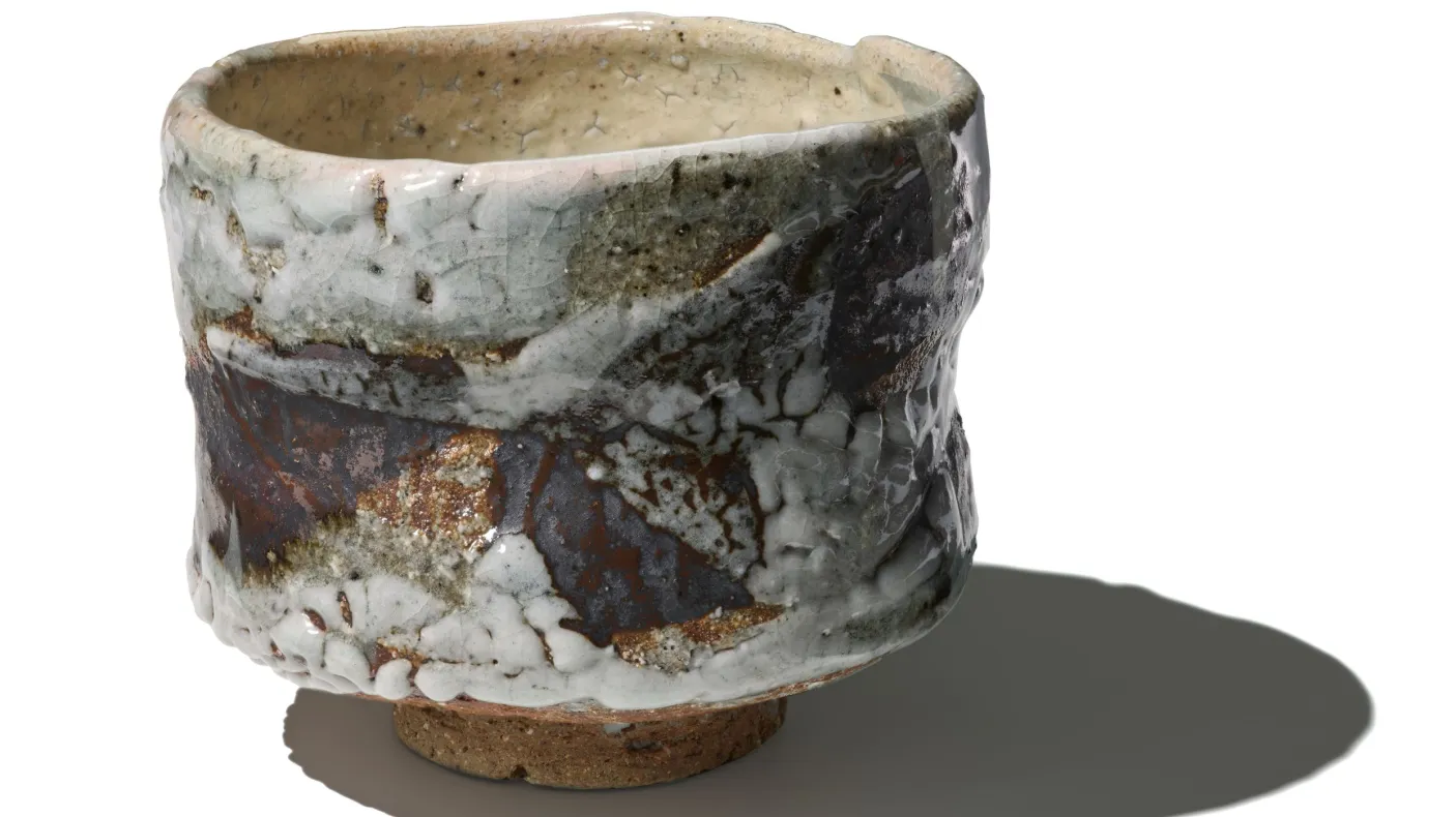 Image of a textured, glazed tea bowl by Japanese potter Ōmine Jissei