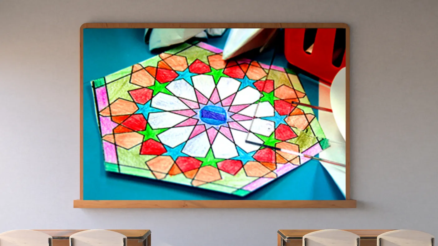 A screen on a classroom wall shows a colourful geometric pattern