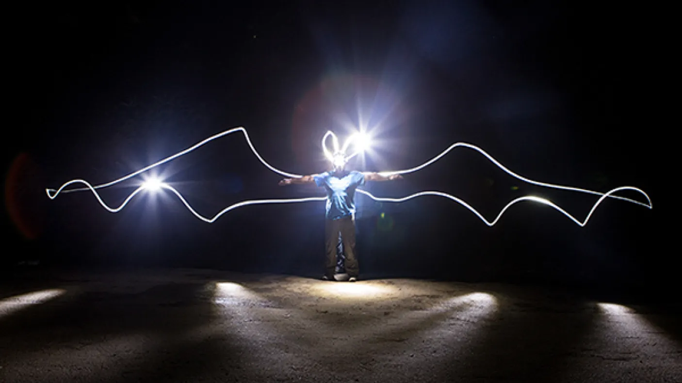 The ROM’s very own ‘Batman’, Assistant Curator of Mammalogy, Dr. Burton Lim with "bat wings" outlined with light in a long exposure photo. Credit: Vincent Luk
