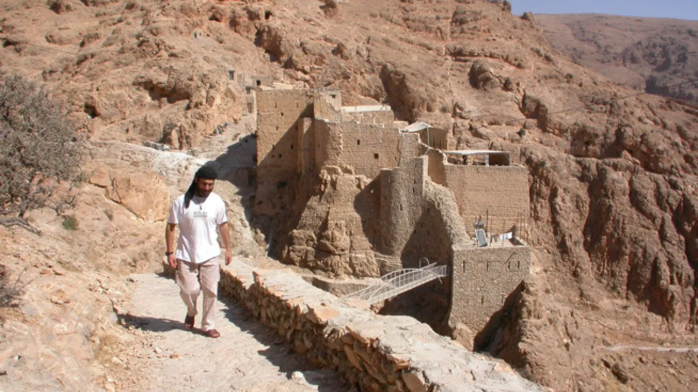 View of the old monastery buildings from the South in 2004, with then Brother Jihad, a member of the monastery.
