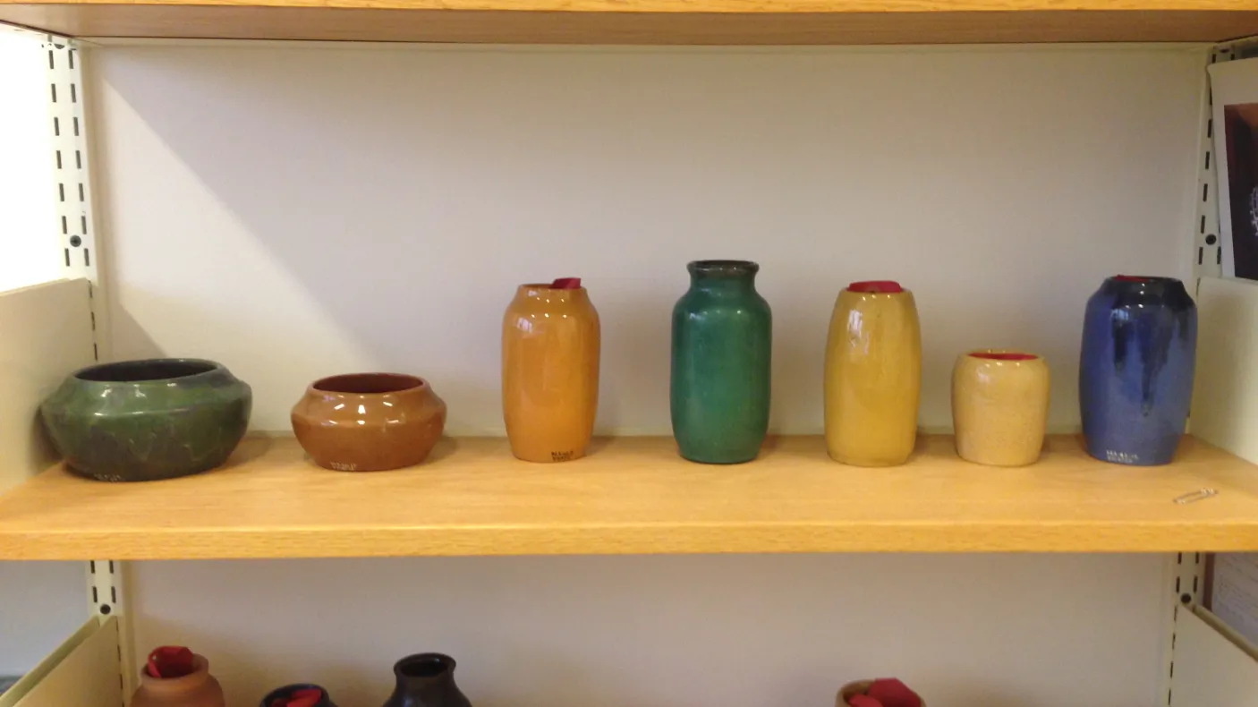 Detail of ceramic vessels on shelf
