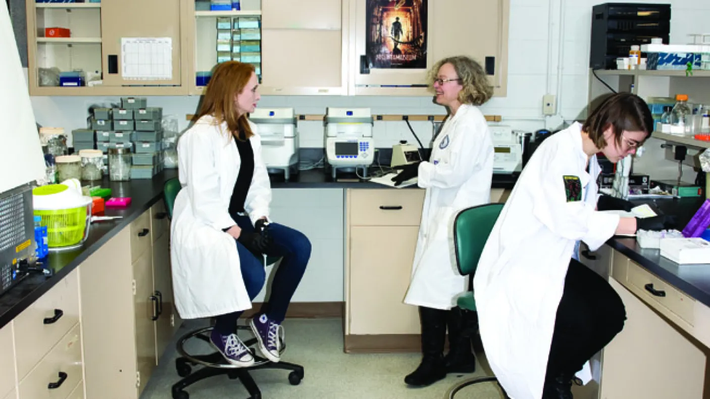 Three women in a lab running DNA testing

