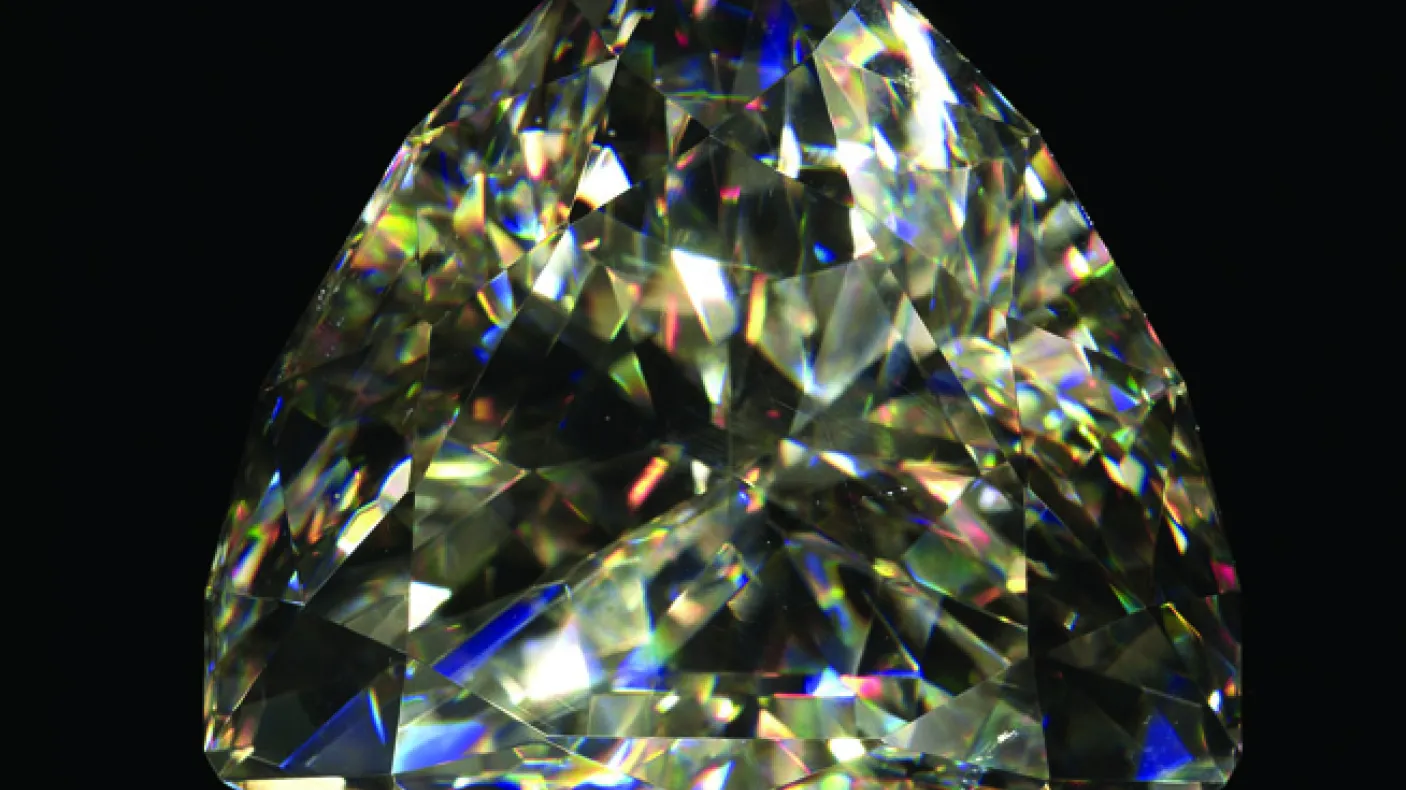 A diamond like gemstone on a black background
