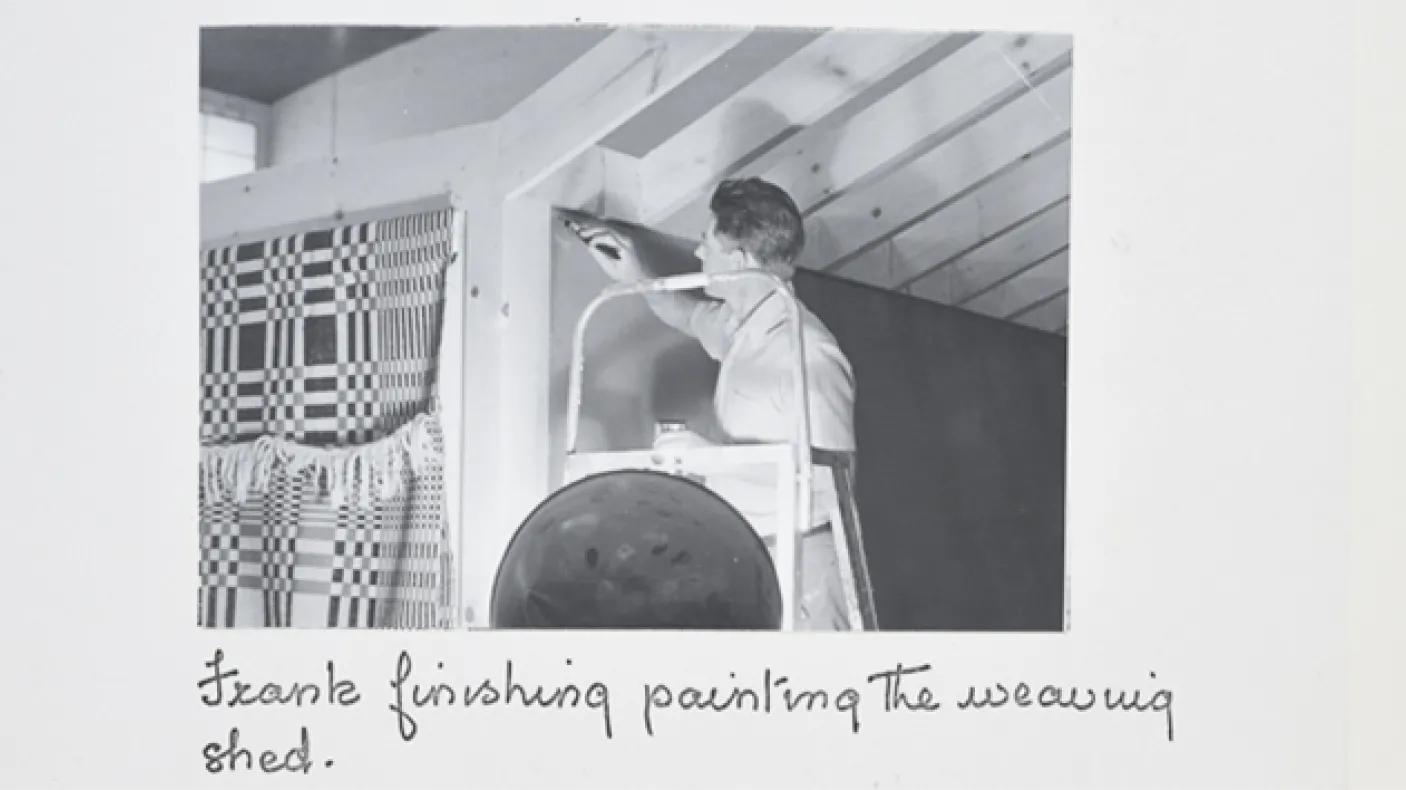 "Frank finishing painting the weaving shed."

