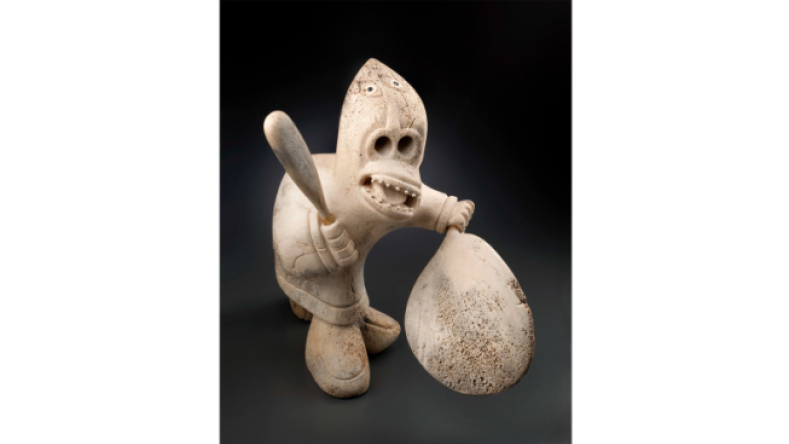 Inuit Art, Dance & Song: Karoo Ashevak (1940-1974). Untitled (Drum Beater). About 1973. Whale bone, ivory, black substance. 46.5 x 29.5 x 51.2 cm. Montreal Museum of Fine Arts, purchase, gift of L. Marguerite Vaughan. © Public Trustee of Nunavut, Estate of Karoo Ashevak. Photo MMFA, Christine Guest.