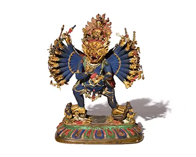 A golden statue of a dragon looking face.