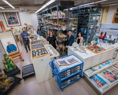 A diverse group of visitors exploring a museum filled with various artifacts and exhibits.