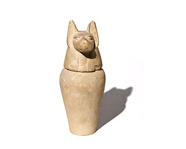Ancient Egyptian dog statue, intricately carved, showcasing the cultural significance of dogs in ancient Egyptian society.