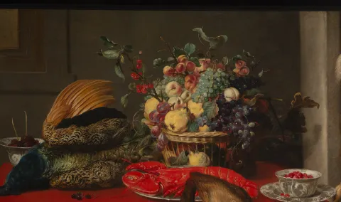 Detail of painting depicting game and fruit laid on a table.