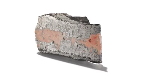 Pie-shaped sample of cobalt mineral encased in smaltite, shown on a white background.