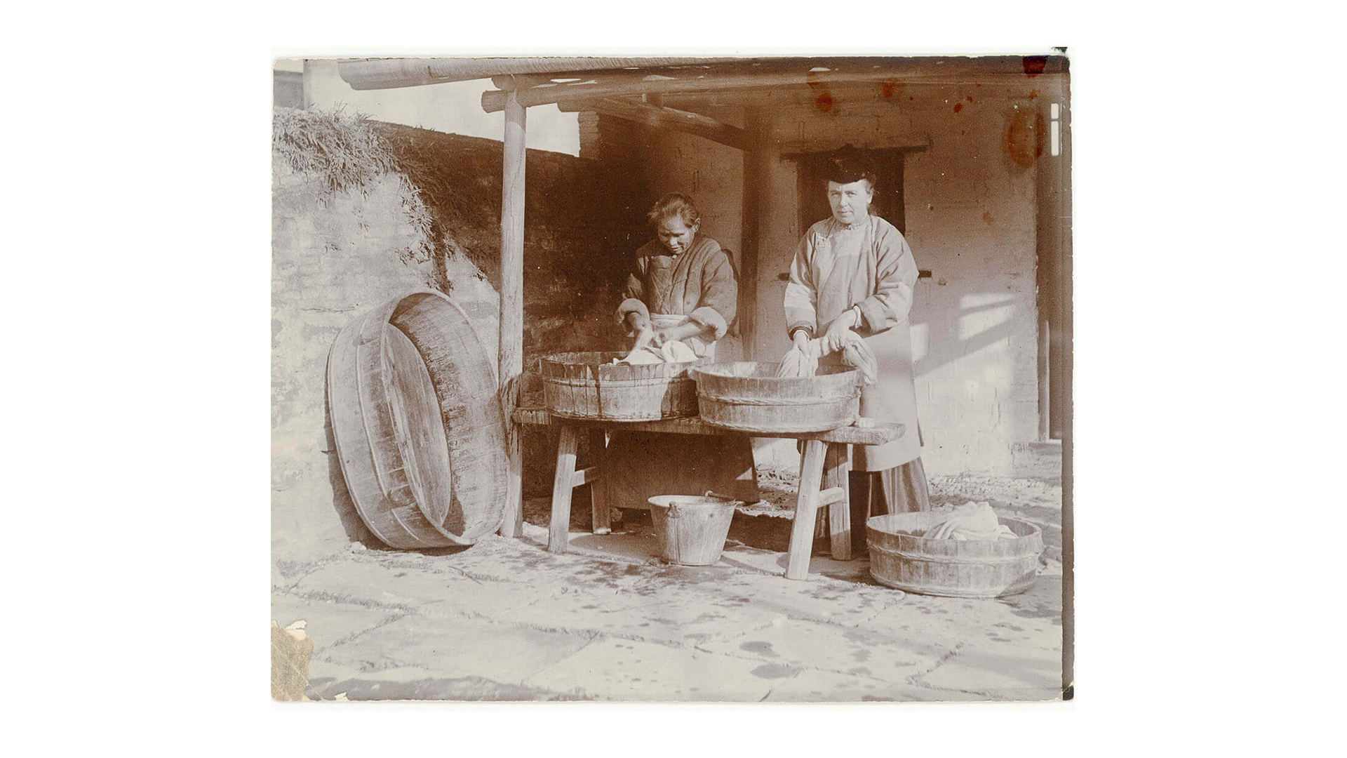 A missionary woman and a Chinese woman washing clothes.